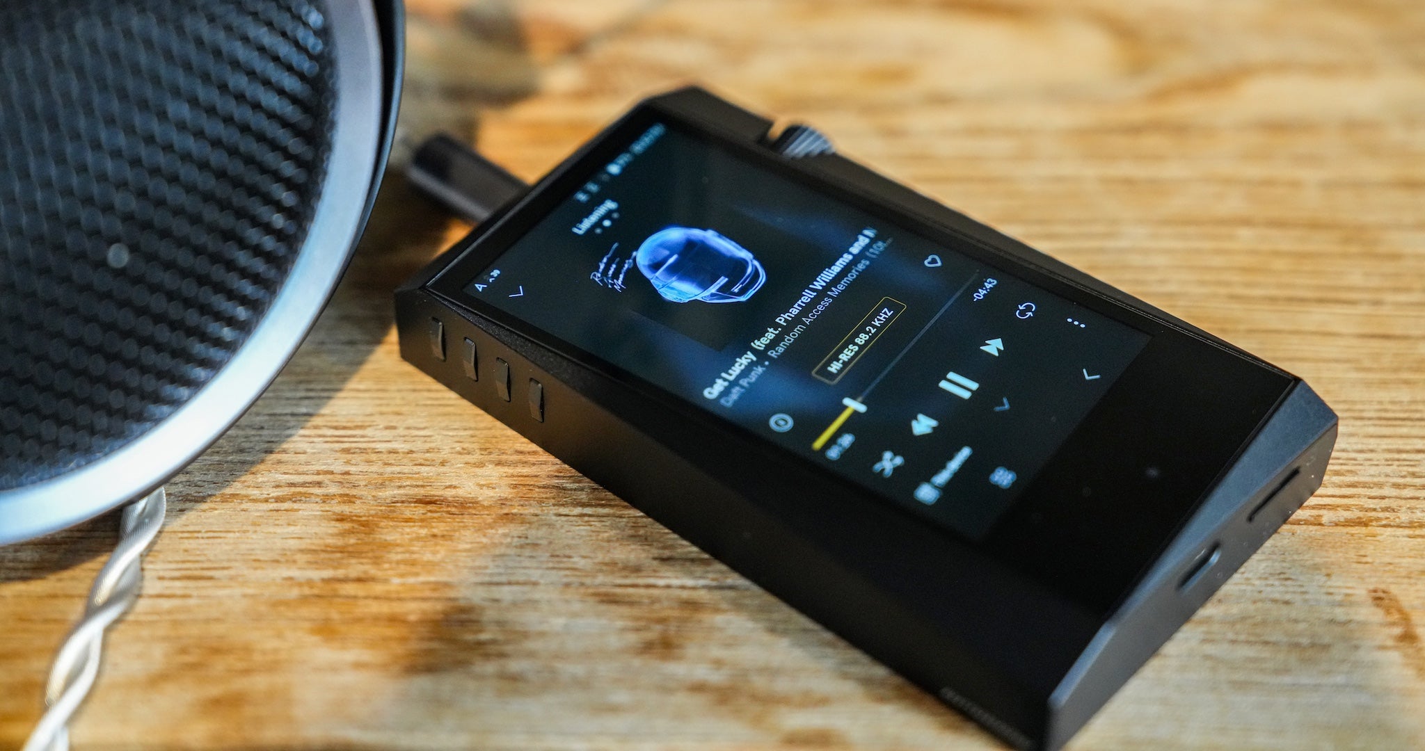 Astell&Kern SR35 player on wood table highlighting LCD screen and UI