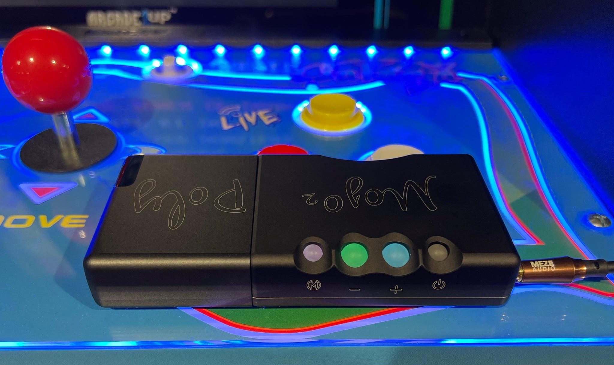 Chord Mojo 2 with attached Poly streamer on arcade cabinet deck