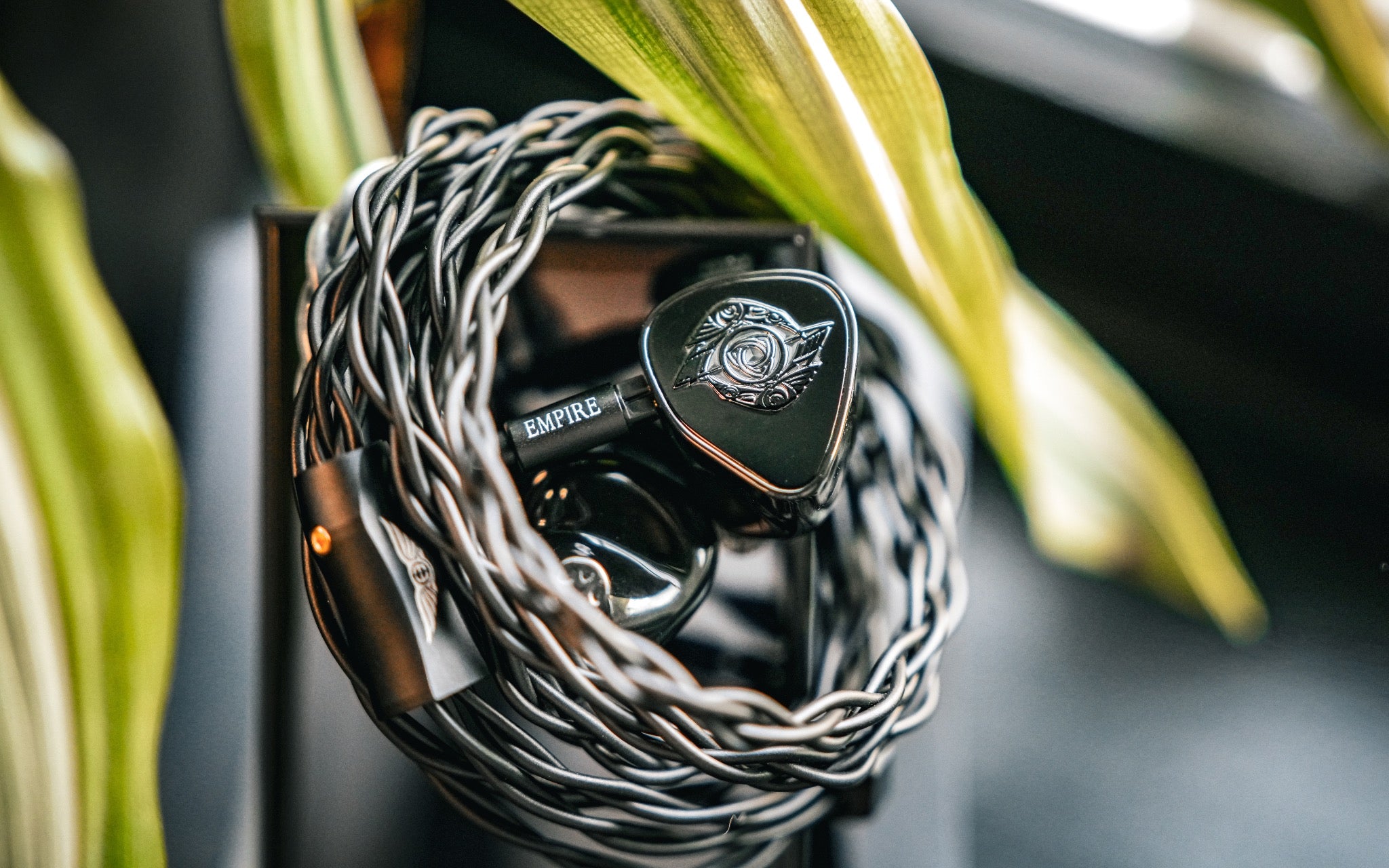 Empire Ears Raven with attached coiled cable and plant from Bloom Audio gallery