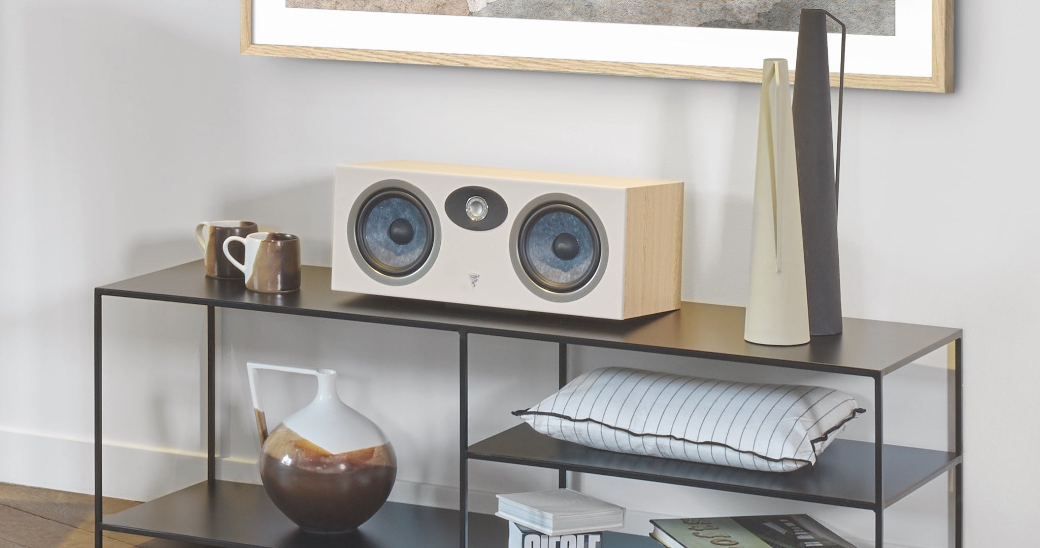 Focal Theva center speaker on glass stand with home decor