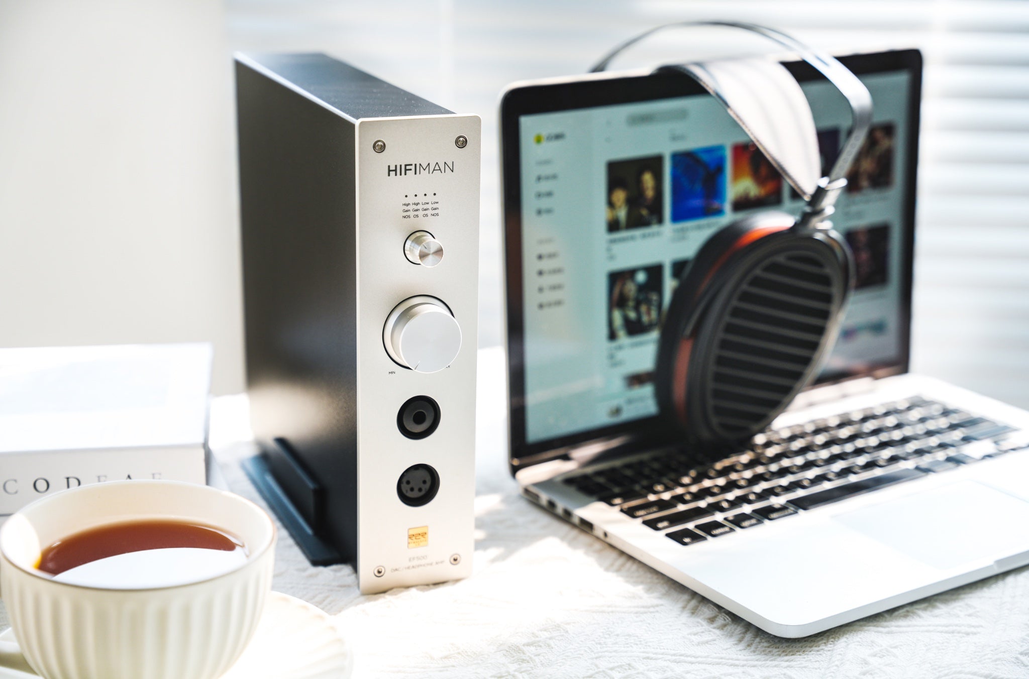 HiFiMAN EF500 DAC front left quarter with Macbook, Arya headphones, and cup of coffee