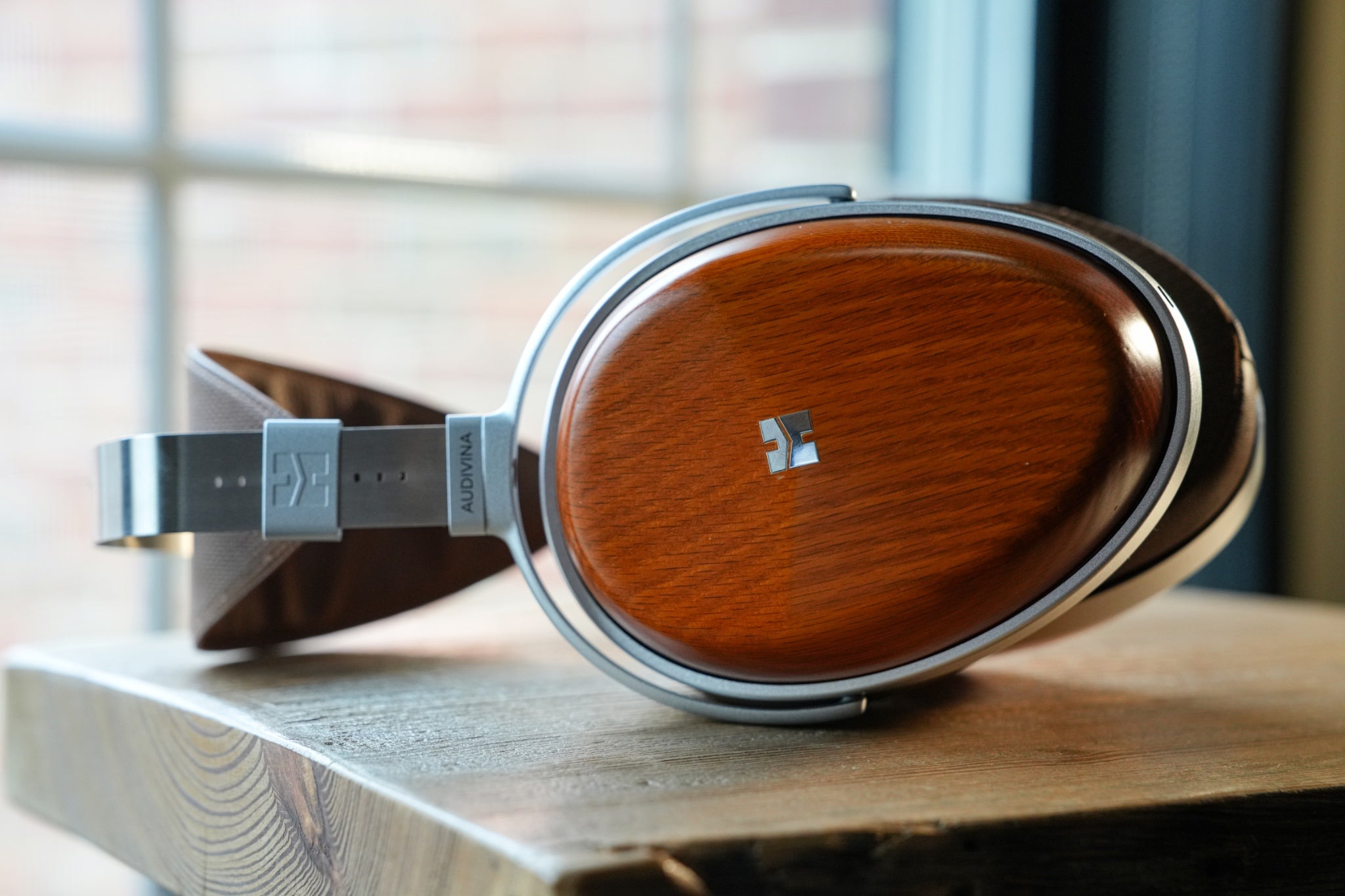 HiFiMAN Audivina headphone on wooden table in front of window from Bloom Audio Gallery