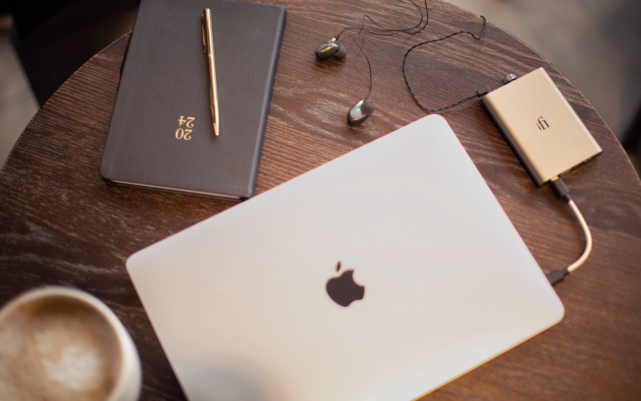 iFi hip-dac 3 connected to Apple Macbook on wood table with Cappuccino