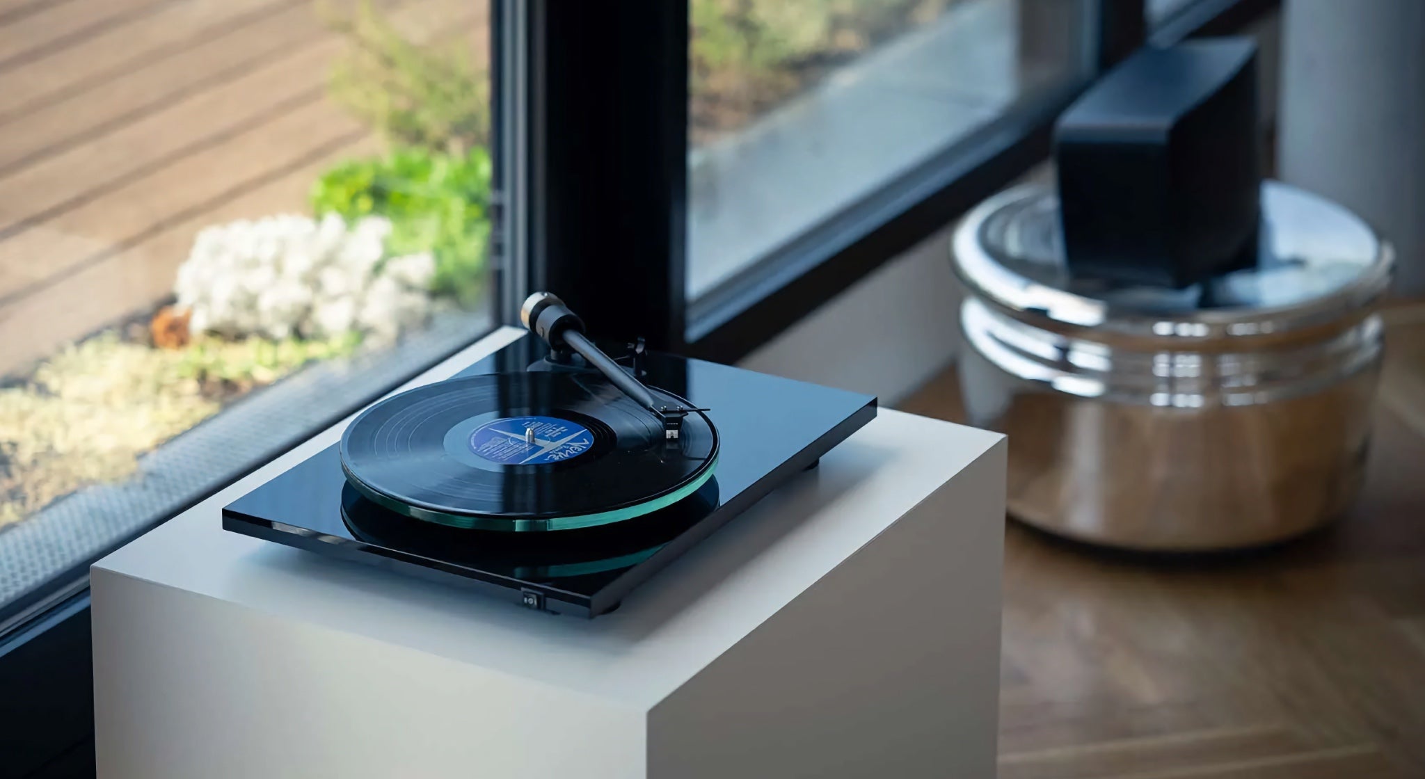 Pro-Ject T2 black on white decorative cabinet in living space
