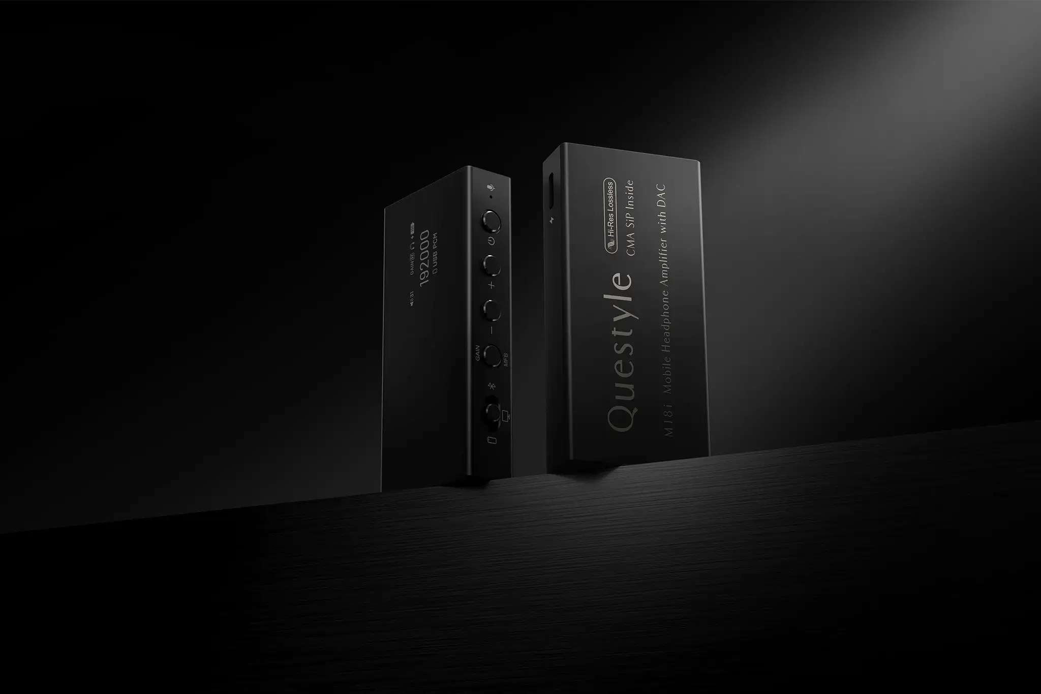 Questyle M18i DAC/Amp front and back sitting on black table side lit on black background