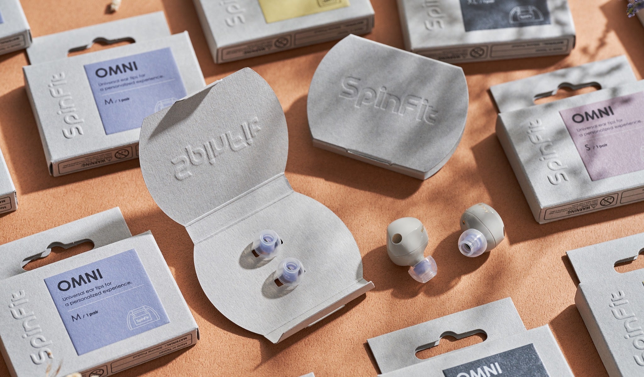 SpinFit retail boxes and inserts highlighting tips and plastic-free, recycled paper design