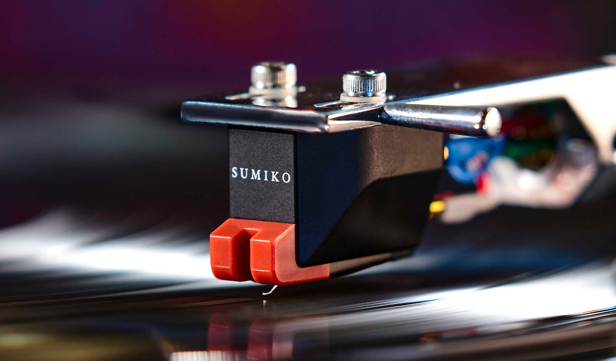 Sumiko Moonstone cartridge top 3 quarter closeup mounted on tonearm over spinning record