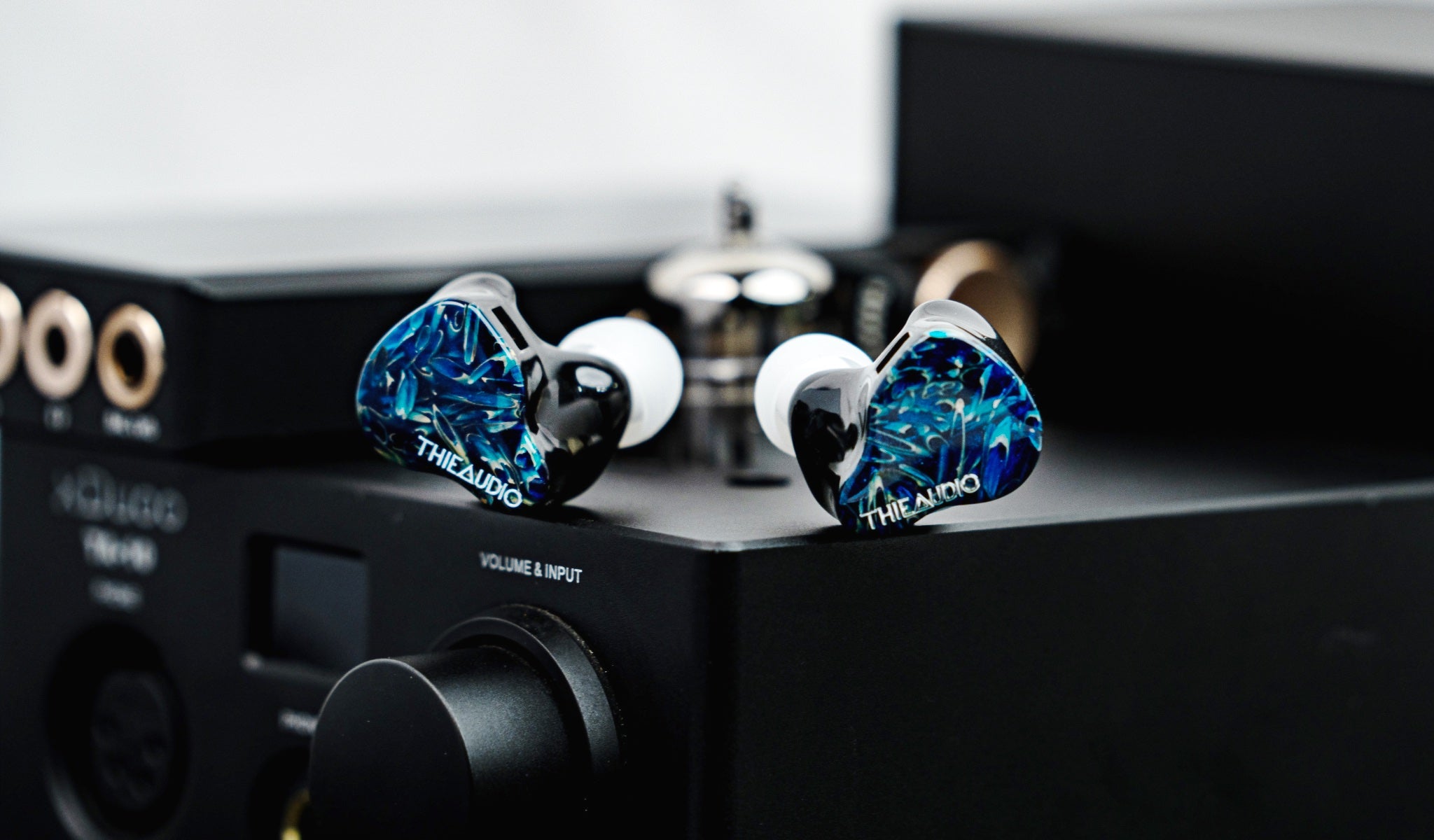 Thieaudio Hype 2 blue with eartips on desktop amplifier