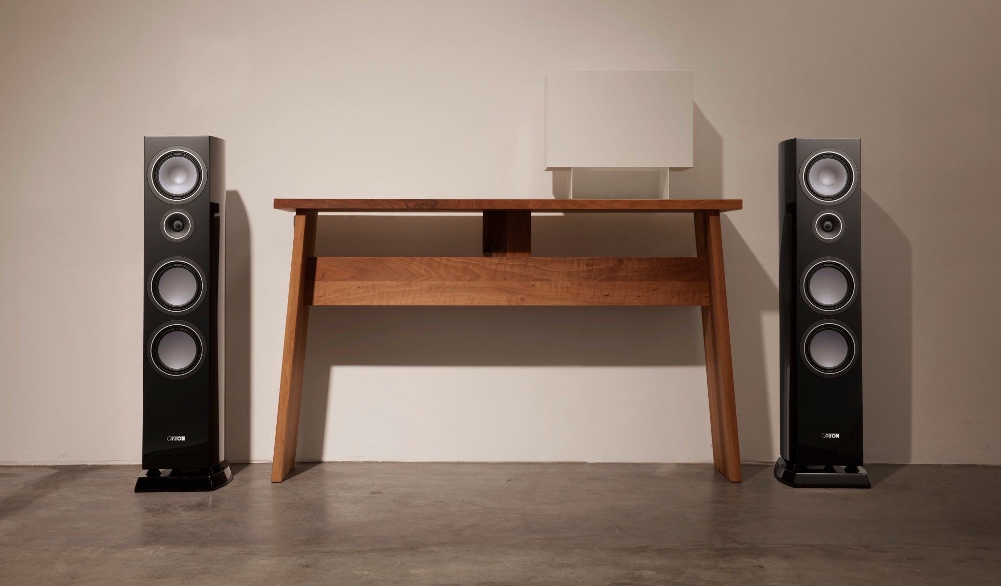 Canton Vento 80 floorstanding speaker pair in living space with end table