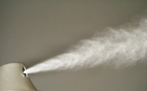 Deodorant spay close up in the air.