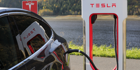 Tesla charging point plugged into a car.