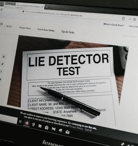 Computer screen showing lie detector test paper with pen.