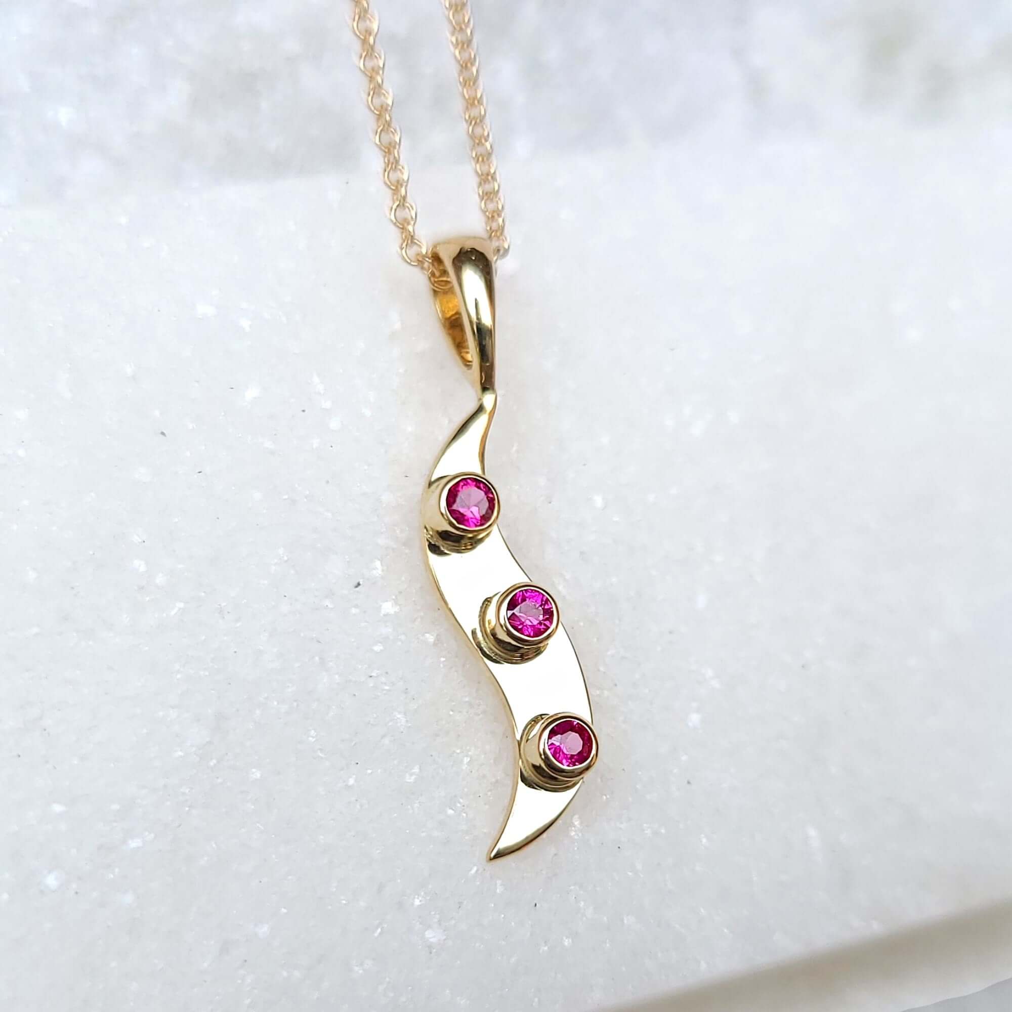 Image of 14K Elegant Yellow Gold Ruby Wave Necklace