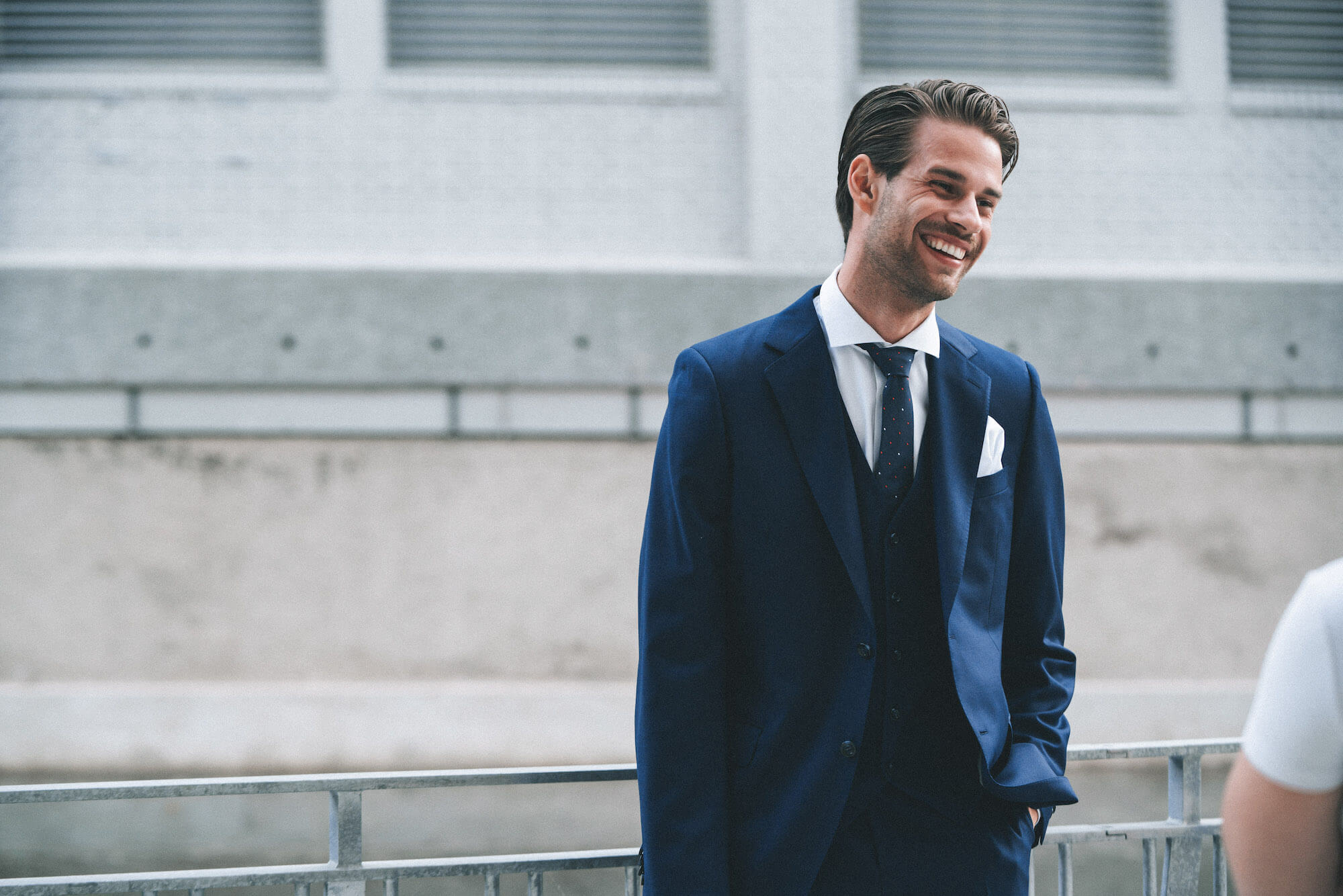 Laughing man in a blue suit with a dark blue tie