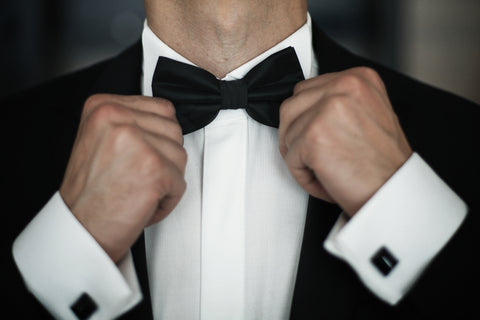 A bow is tied on a black tuxedo