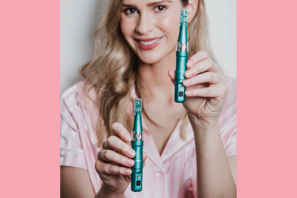 a woman holding two Dr. Pen A6S microneedling Pens