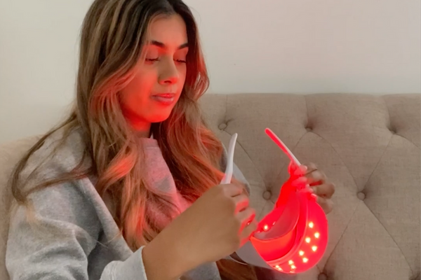 a woman about to use zobelle glow led light therapy mask