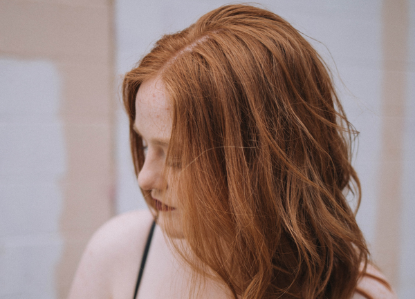 Portrait of a young woman with fair skin and freckles 