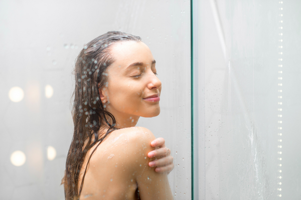 A young woman smiling in the shower
