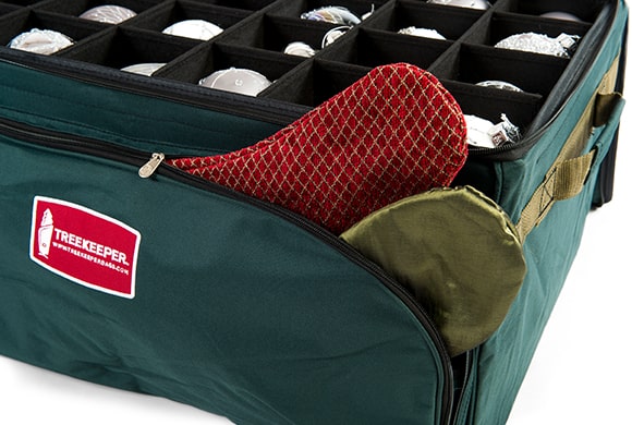 TreeKeeper Bags Three Tray Ornament Storage Bag with Side Pockets and front pocket holding a Christmas stocking