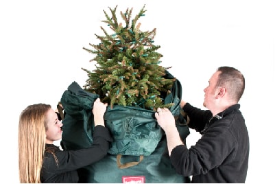 Man and woman covering up Christmas tree with Upright Christmas Tree Storage Bag