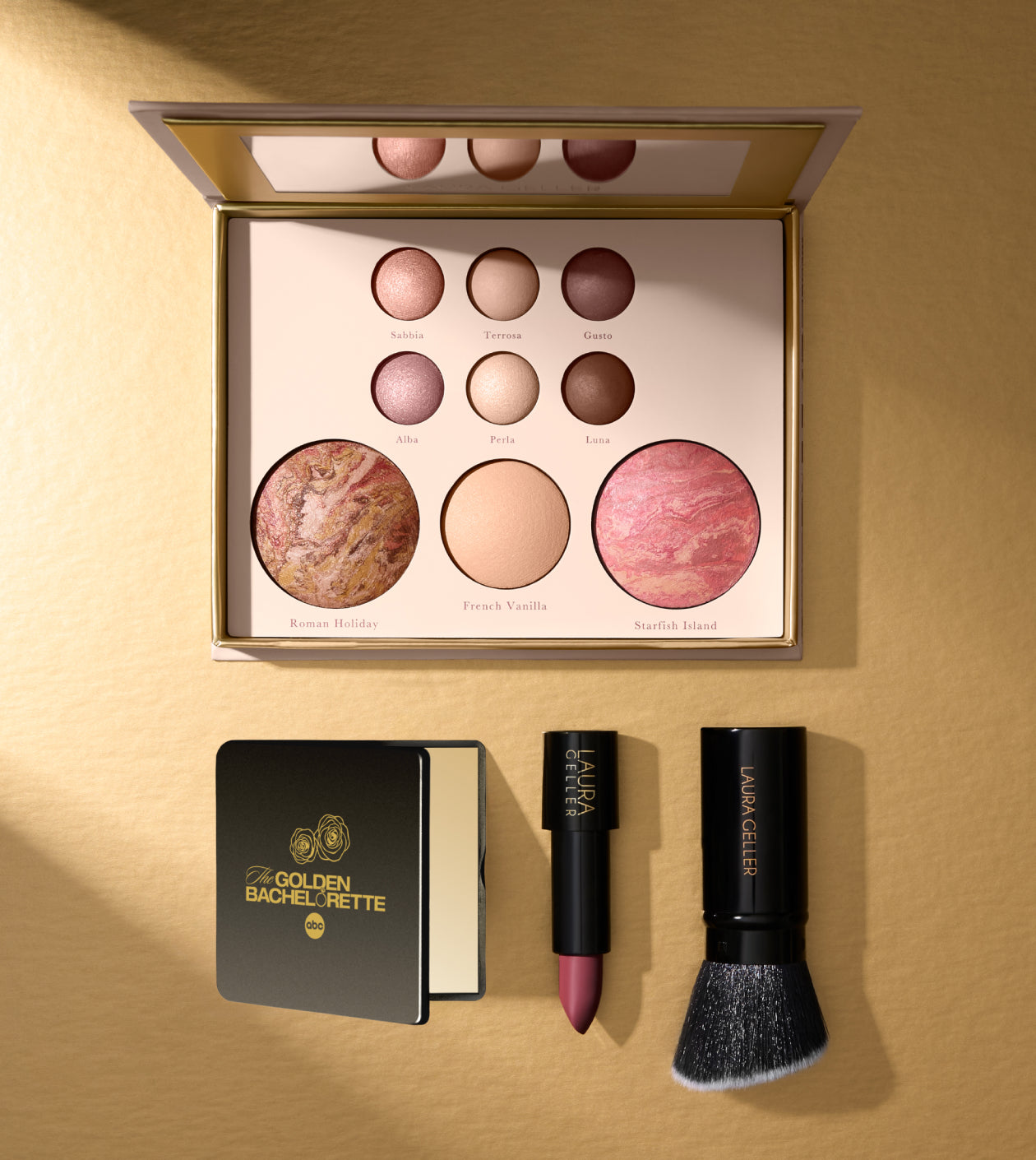 Makeup palette with labeled shades, a compact, lipstick, and a brush on a gold background.