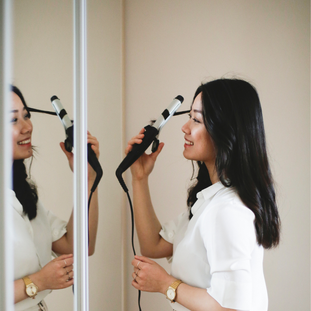 Girl grinning while doing daily hair care