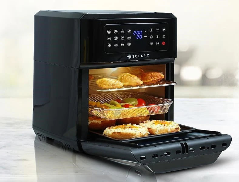 A black air fryer oven with various foods cooking on multiple trays.