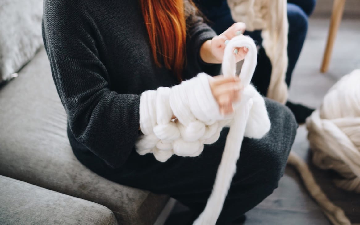 Knitted and Folded Chunky Blanket with Knitting Needles, Yarn Ball in Human  Hands on Neutral Background Stock Image - Image of craftsmanship, craft:  208859619