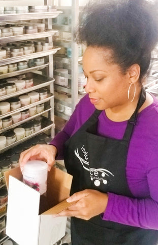 Replica Surfaces customer Stephanie Willoughby of Indulgence Spa and Body packs up products for shipping