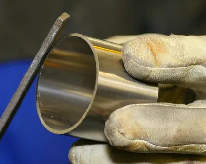 Using a file to prepare and clean the stainless steel pipe for TIG welding