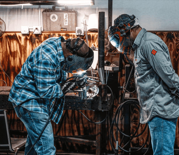 welding instructor and welder are in the welding school