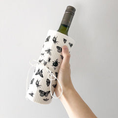 wine bottle with a sponge cloth wrapped around it and tied with twine to give as a gift