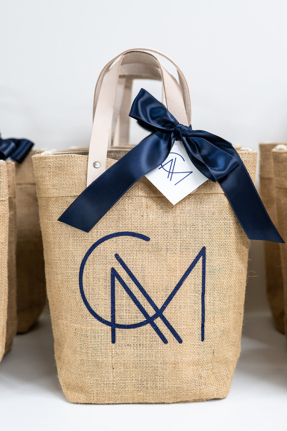 custom wedding welcome gift bags jute beach tote with monogram by Marigold & Grey