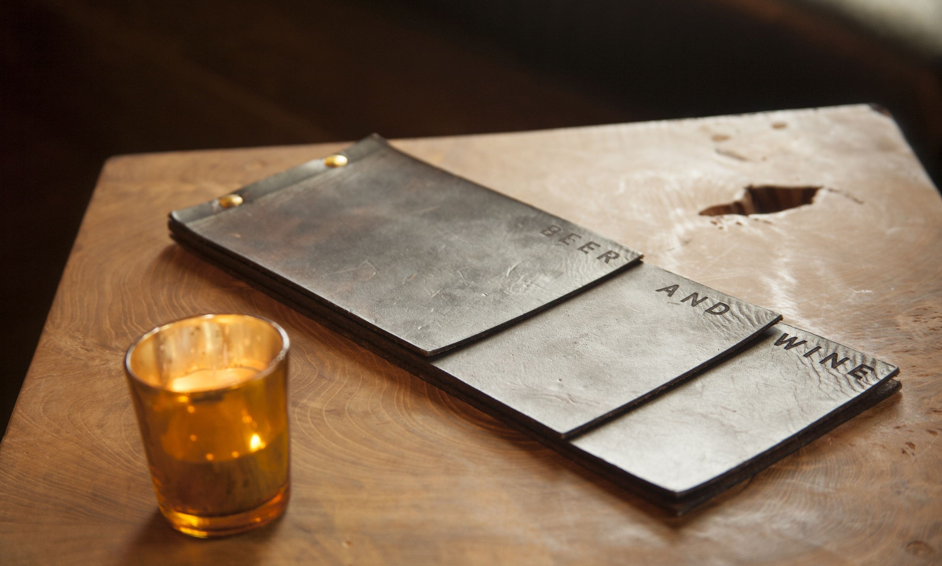 Custom Savilino Beer and Wine menu with candle on table.