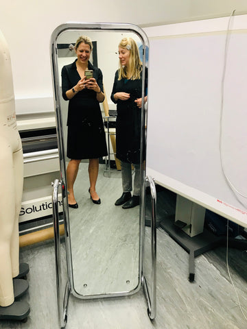 Me with our pattern maker when she told me she was pregnant, trying on our breastfeeding dress in London
