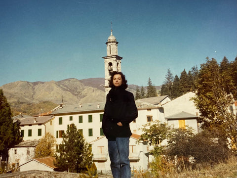 A woman in the 1980s in front of an Italian mountain village 