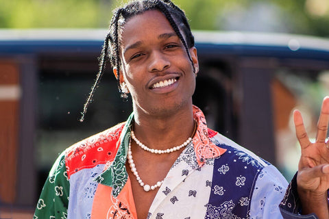 A$AP Rocky wearing a patterned shirt and layered pearl necklaces 