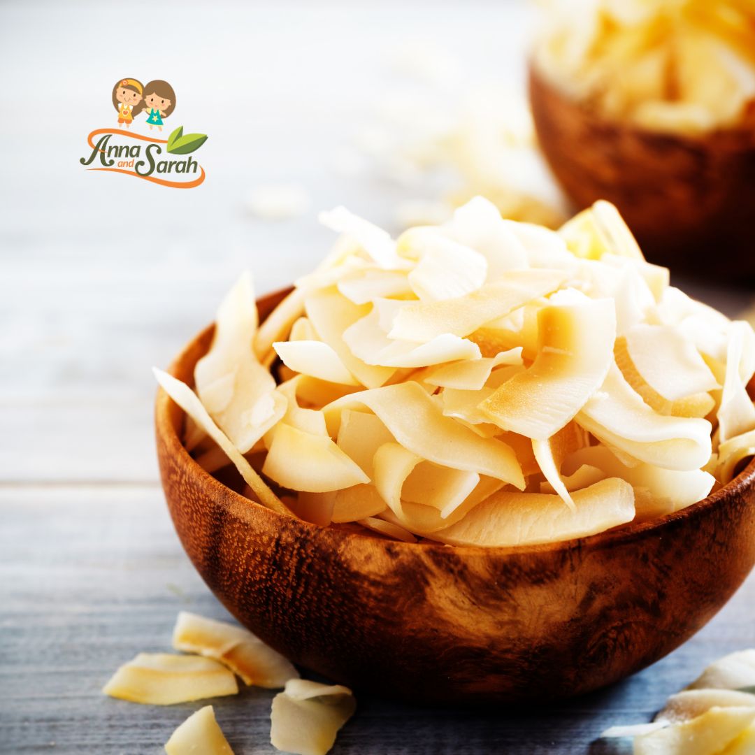 Golden-brown coconut chips spread on a baking sheet, fresh out of the oven.