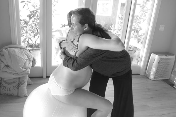 Doula supporting a woman in childbirth