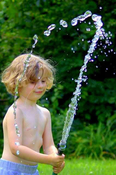 Boy Playing with Garden Hose