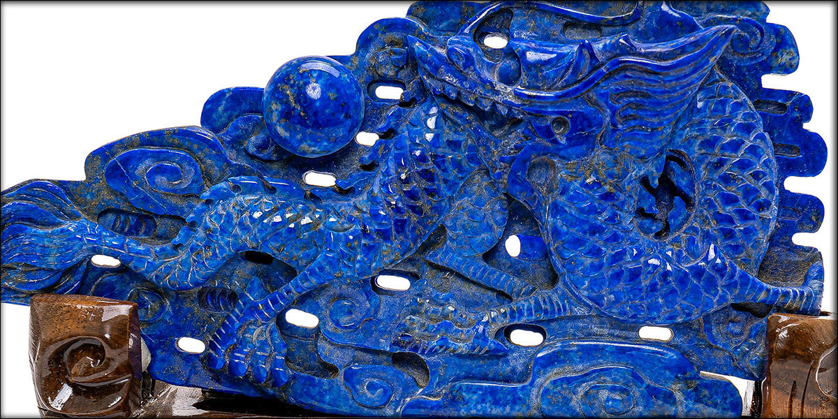 Hand-carved lapis lazuli dragon amidst carved clouds.