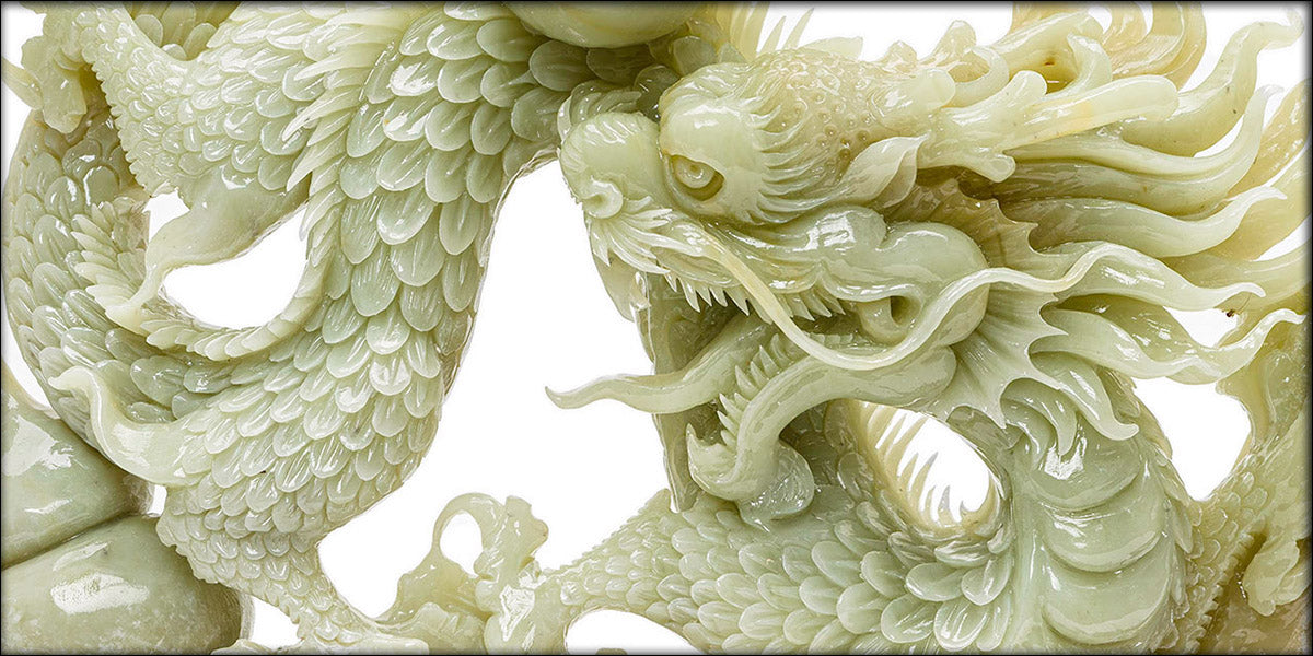 Hand-carved agate sculpture of a dragon with the Pearl of Wisdom on a wooden base.