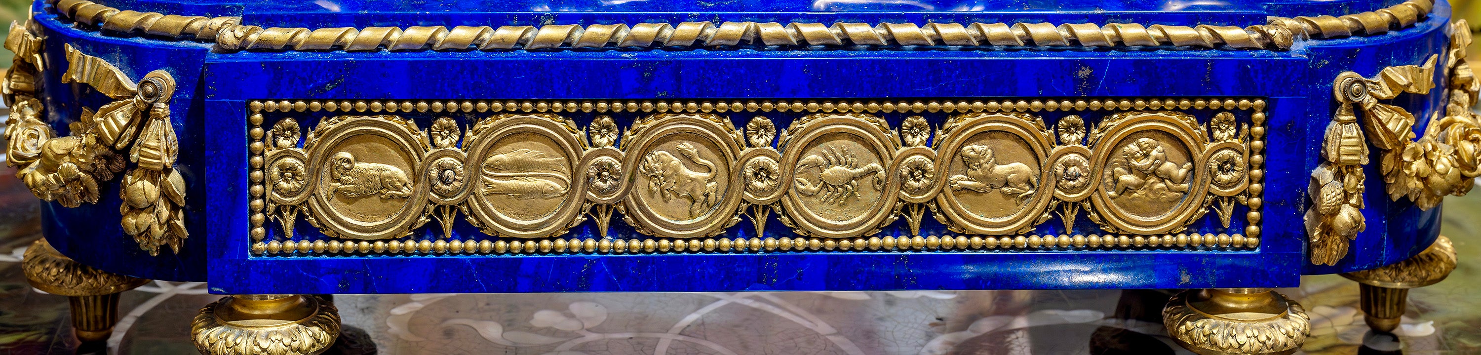 Antique clock with astrological symbols around a Lapis Lazuli base