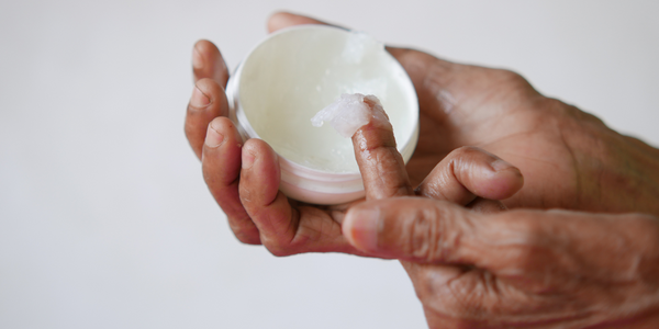 image of hand scooping petroleum jelly