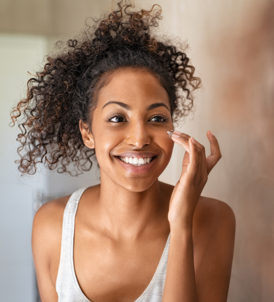 Black Woman applying face cream
