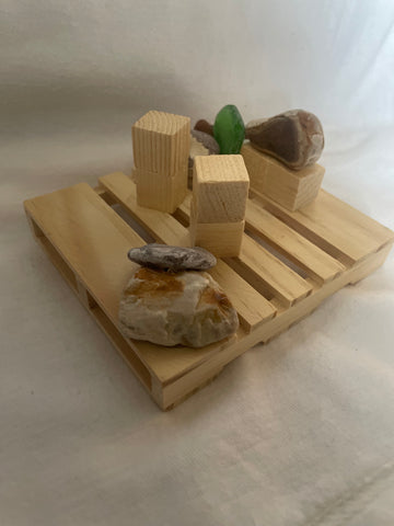 Pictured is a handmade palo santo holder made from stones in the Dominican Republic.