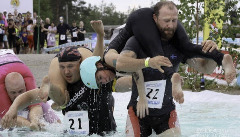 man carrying wife in the wife carrying championship in Finland