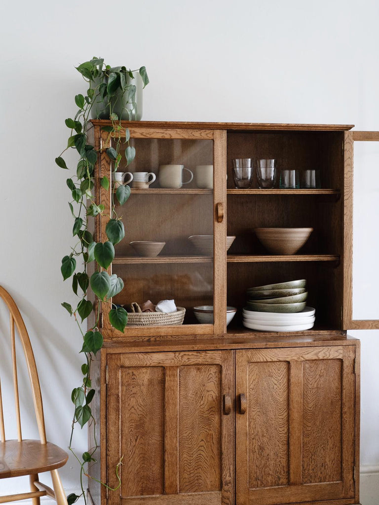 A glass and wooden cabinet from may & co