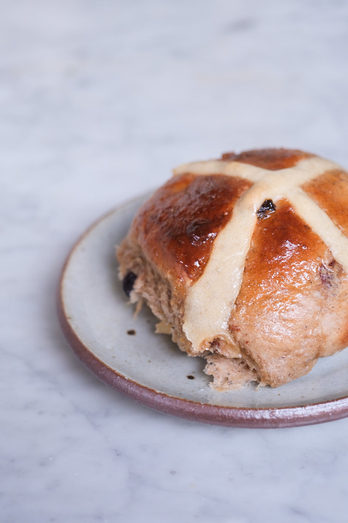 a plate with a hot cross bun 